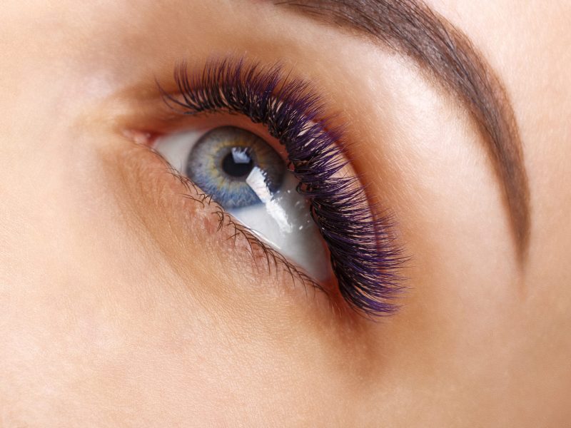 Eyelash Extension Procedure. Woman Eye with Long Eyelashes. Lashes. Close up, macro, selective focus